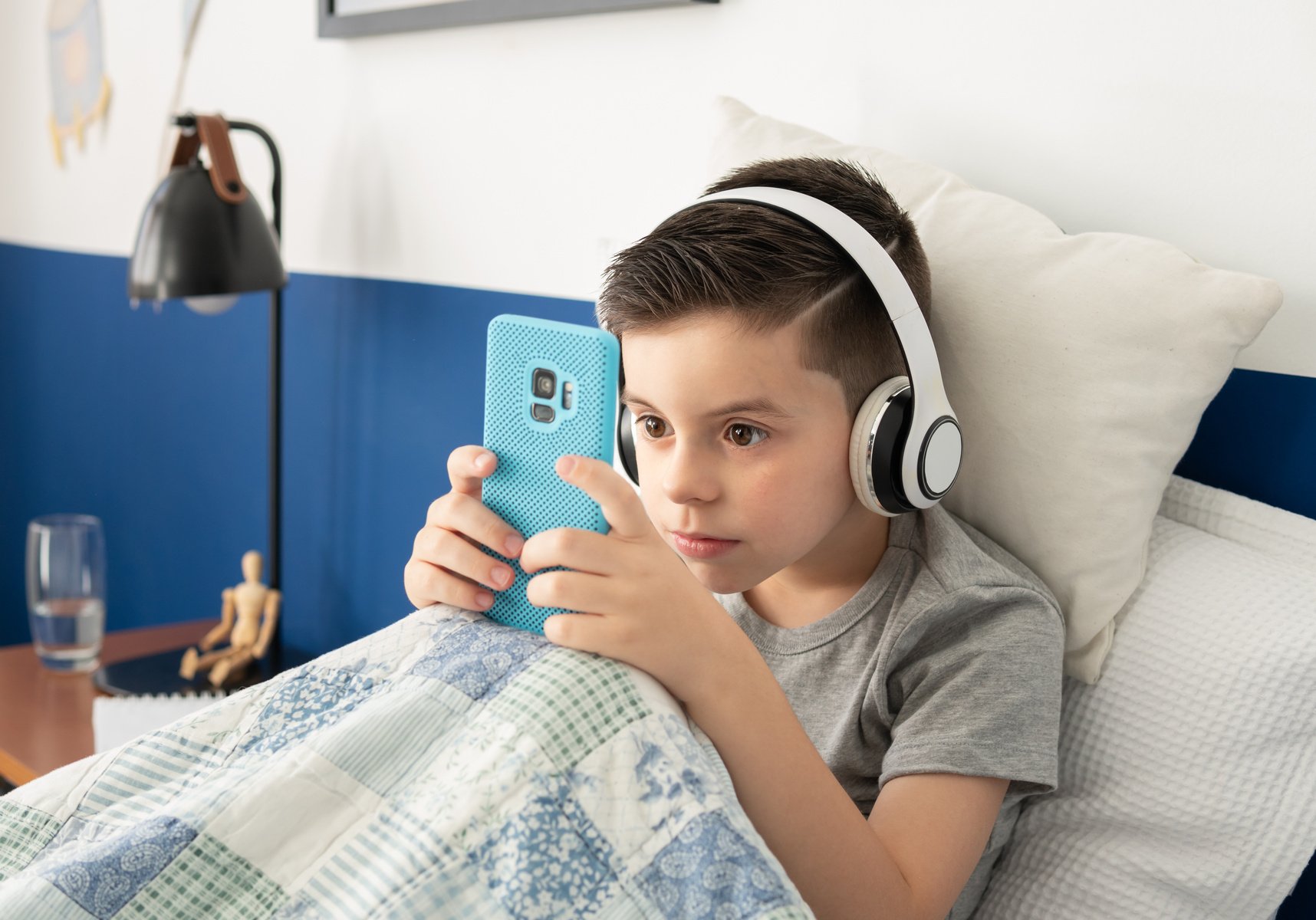 boy plays video games with cell phone